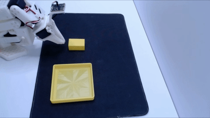 Robot successfully completing the place-yellow-rectangle task after training